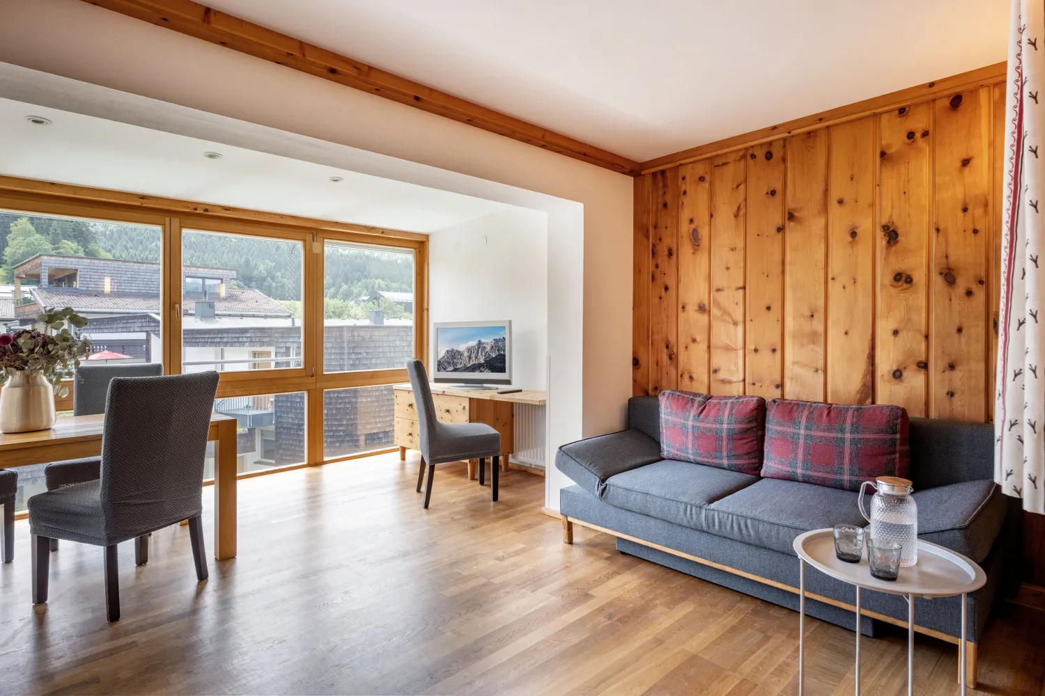 Wohnraum mit Zirbenholzwand, Sofa und Essplatz im Superior Studio Top 23
